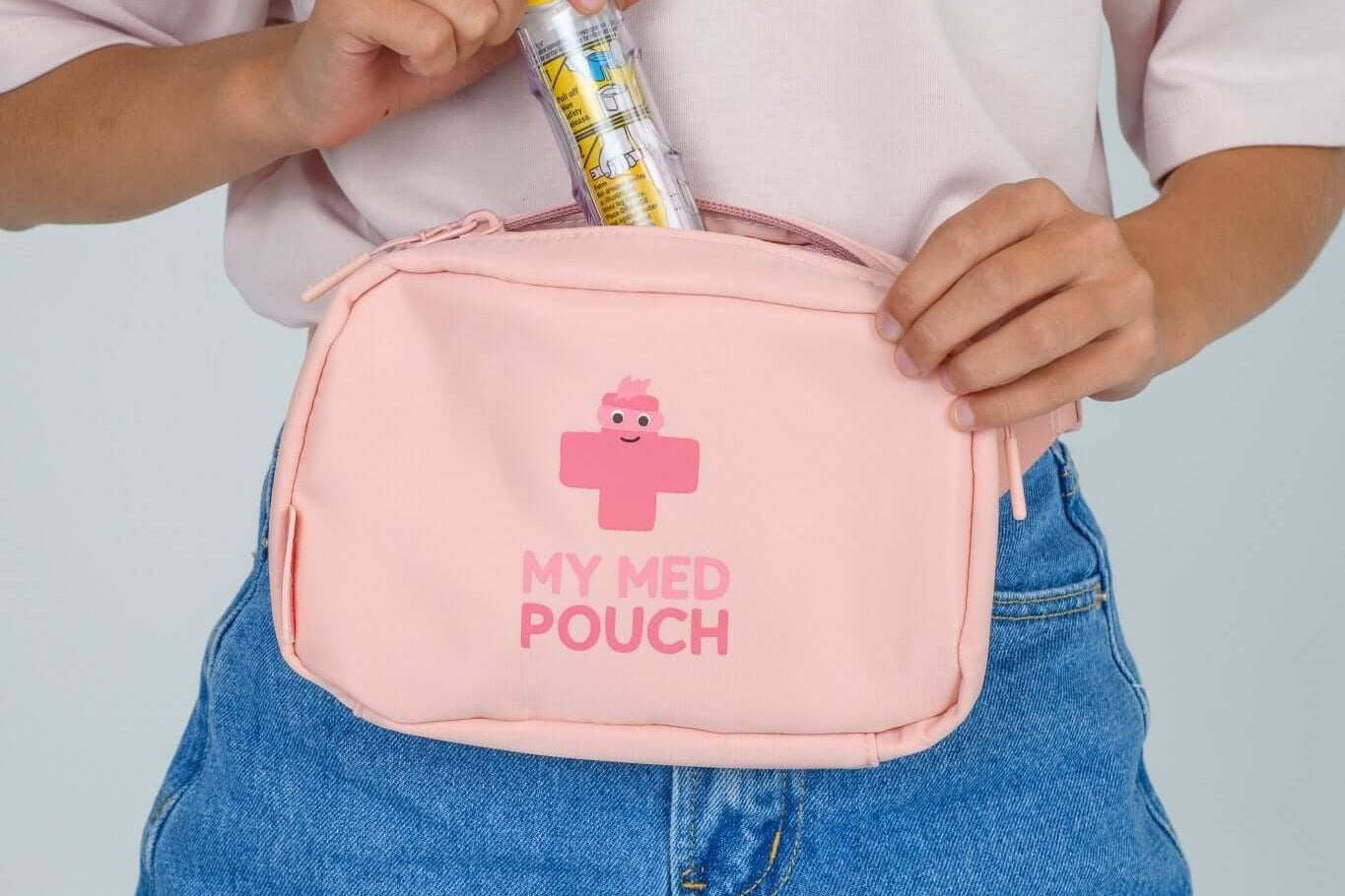 Peachy Pink Med Ready Bag - front view worn as waist pack and showing child putting in epipen.
