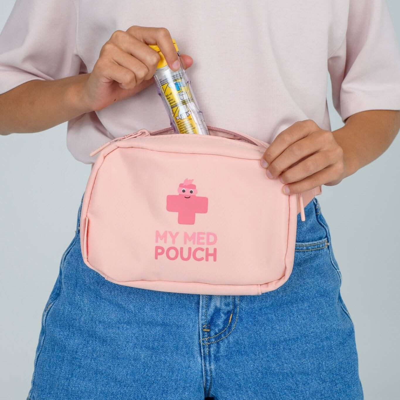 Peachy Pink Med Ready Bag - front view worn as waist pack and showing child putting in epipen.