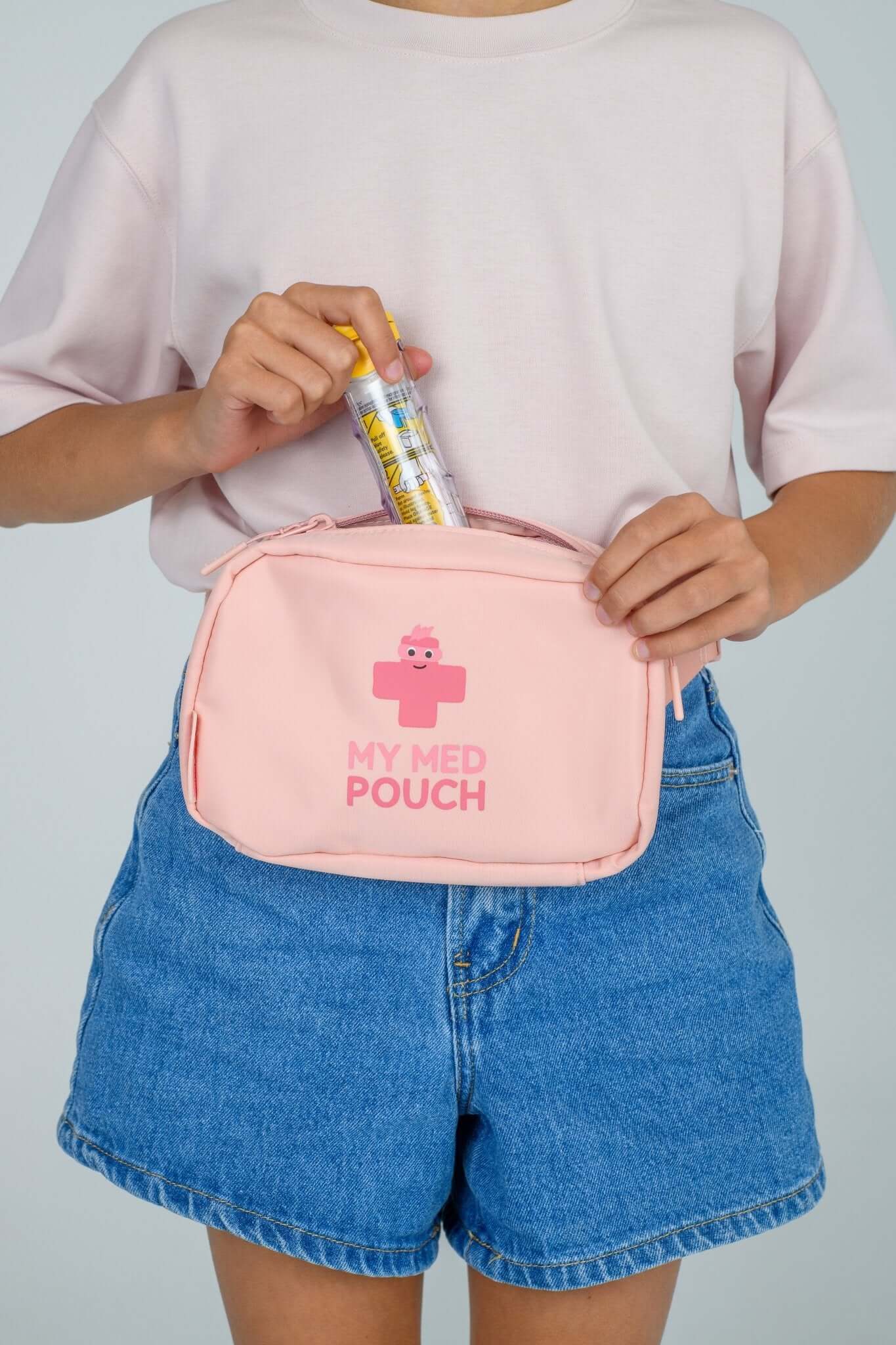 Peachy Pink Med Ready Bag - front view worn as waist pack and showing child putting in epipen.