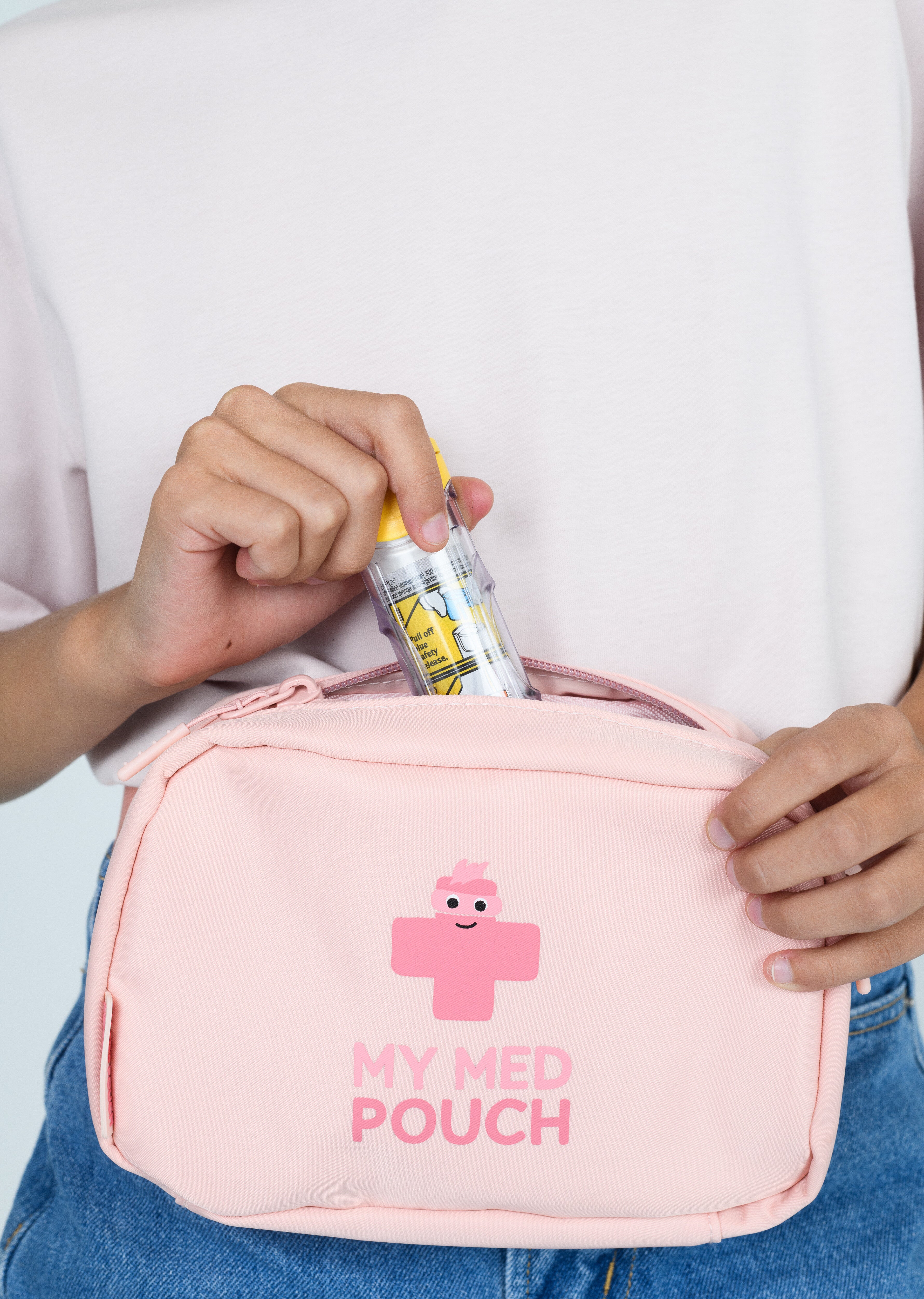 Child putting epipen into peachy pink Med Ready Bag